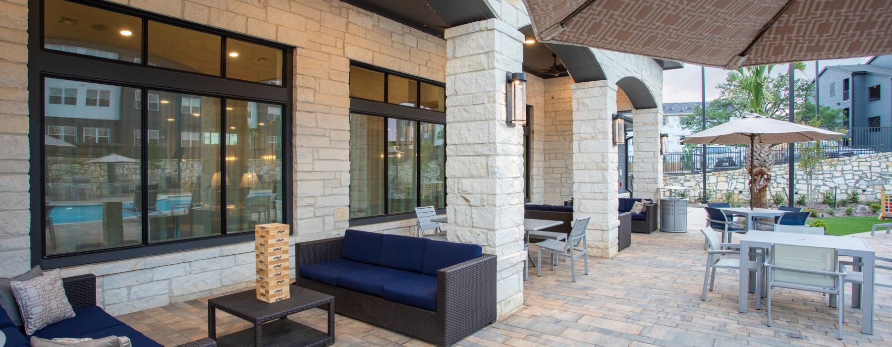 a patio with a couch and chairs